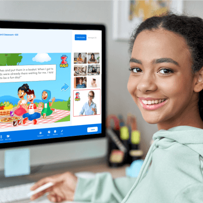 Girl smiling in front of a computer
